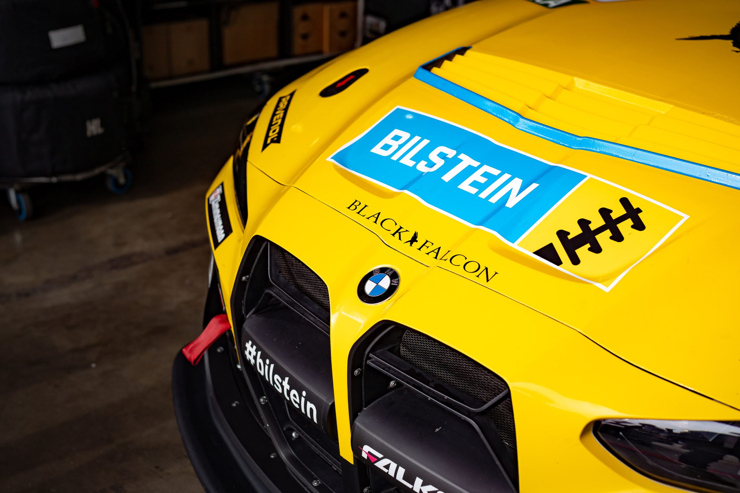 Yellow-foiled and branded radiator grille of the BILSTEIN BMW M4 GT4 Race Car